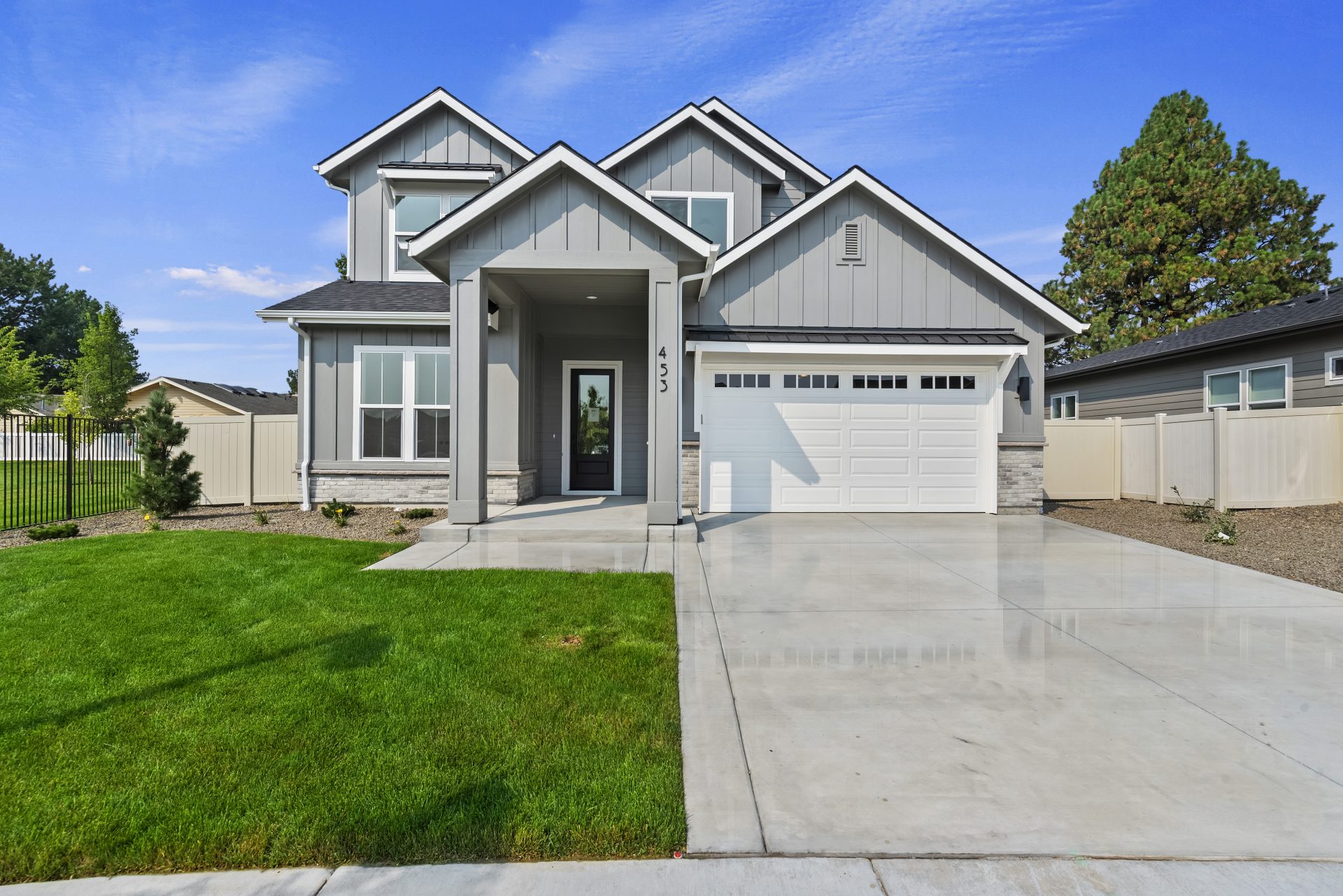 View of front exterior of a 2-story home painted grey.
