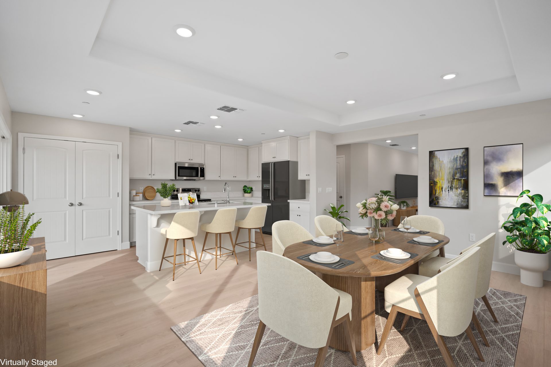A virtually staged dining area and kitchen with a six person wooden table with natural cloth and wood toned chairs, medium brown area rug and various décor items.